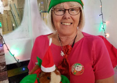 Loose Valley staff member with their guinea pig in elf fancy dress