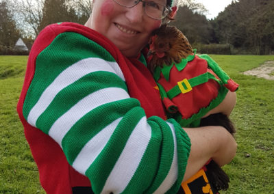 Loose Valley staff member with their chicken in elf fancy dress
