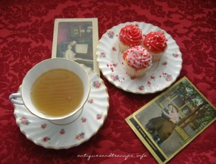 Tea and cake set out on a table with vintage photos