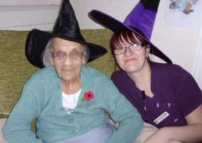 Loose Valley staff member with a resident wearing black and purple witch hats