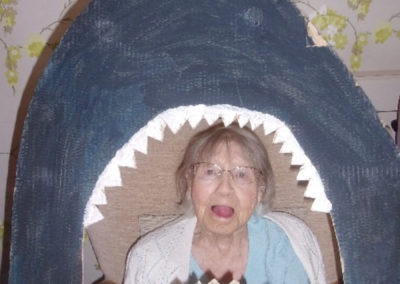 Lady resident posing with a cut-out Jaws decoration