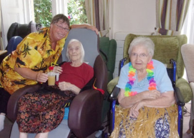 Staff and residents at the Hawaiian party
