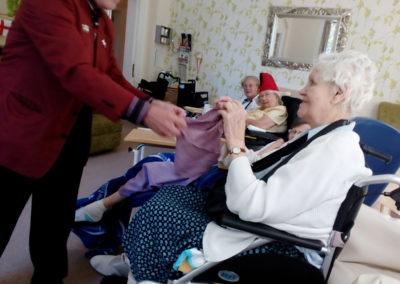 Magician Terry Knight performs a close-up magic to a resident at Loose Valley Care Home
