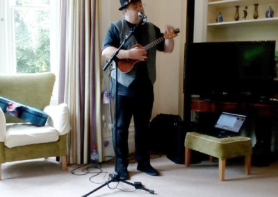 Live musician performing a song with a ukulele