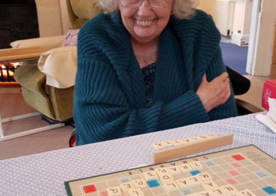 Lady resident at Loose Valley Care Home enjoying a game of scrabble