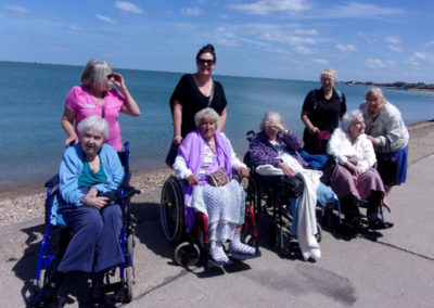 Loose Valley residents and carers posing for a photo on the sea front