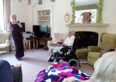 Female singer performing for Loose Valley Care Home residents