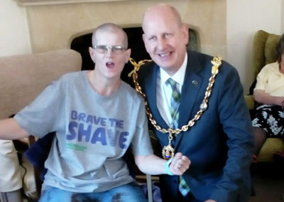 Loose Valley staff member excitedly posing for the camera with local Mayor Councillor David Naghi after having her head shaved to raise money for Macmillan Cancer Support