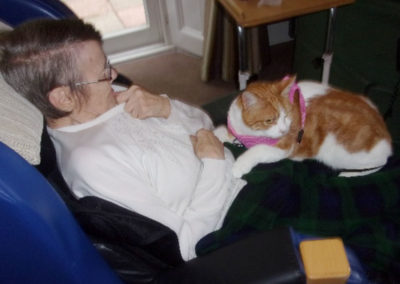 Loose Valley resident with Oliver the ginger and white cat on her lap