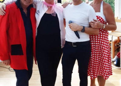 Staff and entertainer at Loose Valley at a Grease themed party