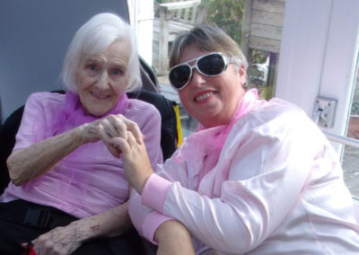 Staff member and resident dressed in pink
