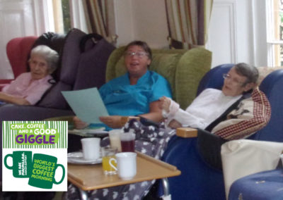 Staff and residents singing along with an entertainer in their lounge