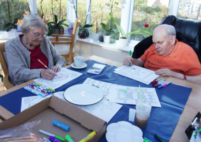 Two residents at Loose Valley colouring in Australian themed pictures