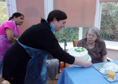 Lady resident receiving her birthday cake