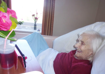 Lady resident smiling during a virtual Pet Therapy session at Loose Valley Care Home