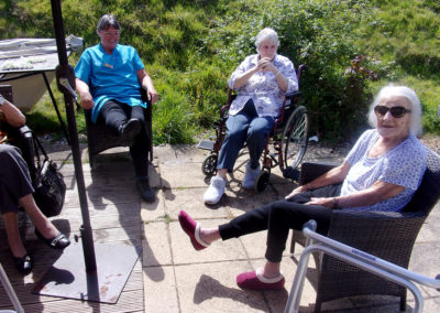 Residents sitting together in the garden at Loose Valley Care Home
