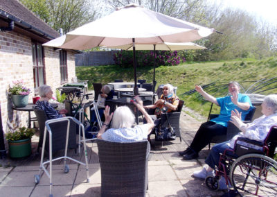 Residents doing seated exercises in the garden at Loose Valley Care Home