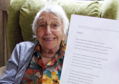 Loose Valley Care Home resident Audrey holding up a print out of her 'Nurses' poem
