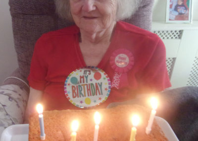 Resident with her birthday cake at Loose Valley Care Home