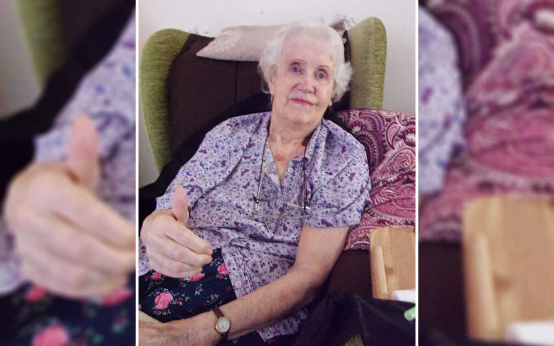 Jean enjoys a family video at Loose Valley Care Home