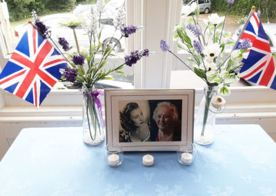 Tribute to Dame Vera Lynn with with Union Jacks, flowers, candles and photos