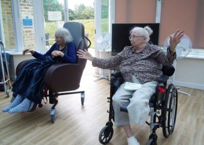 Residents joining in a seated exercise class