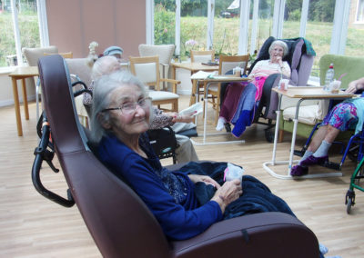 Residents in their conservatory enjoying a music and exercise group together