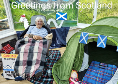 Scotland themed postcard featuring a resident at Loose Valley Care Home