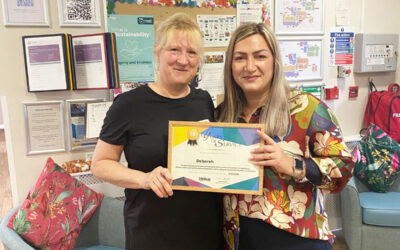 Debbie receiving a certificate in recognition of 15 years of service at Loose Valley Care Home.
